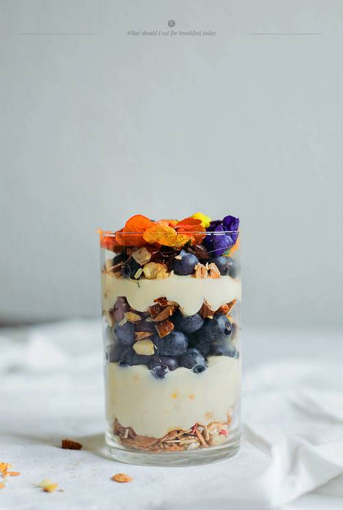 Granola with lemon yogurt and edible flowers